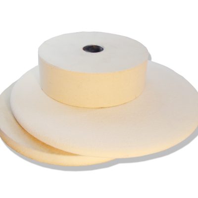 Stack of white felt contact wheels for Bader grinders and polishers