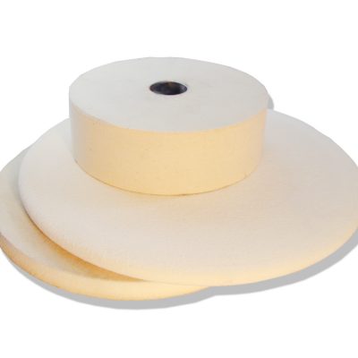 Stack of white felt contact wheels for Bader grinders and polishers
