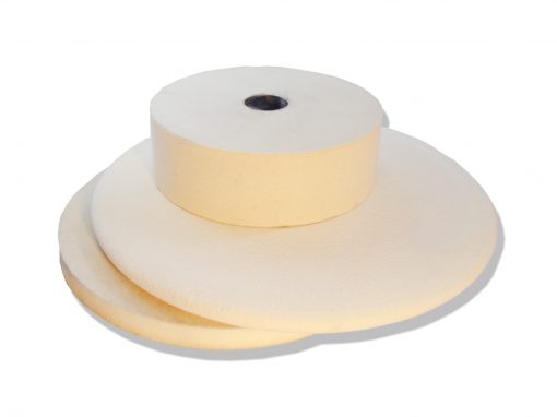 Stack of white felt contact wheels for Bader grinders and polishers